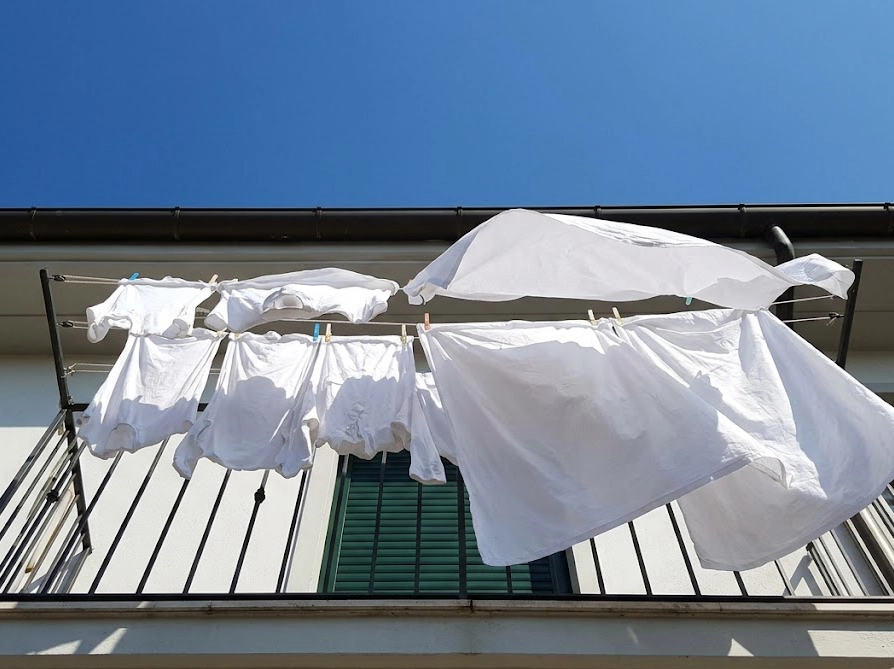 日差しを浴びてベランダに干された洗濯物。香りを残すための干し方の工夫